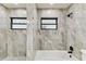 Updated bathroom boasts stylish tile work, modern fixtures, and shower at 6551 S West Shore Cir, Tampa, FL 33616