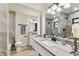 Modern bathroom with updated vanity, gray stone counters, and a beautifully tiled shower and tub combo at 6551 S West Shore Cir, Tampa, FL 33616