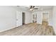 Bright bedroom with a ceiling fan, hardwood floors, and access to a bathroom and closet at 6551 S West Shore Cir, Tampa, FL 33616