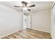 Bedroom featuring wood-look floors, ceiling fan, and view of bathroom at 6551 S West Shore Cir, Tampa, FL 33616