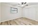 Bedroom featuring wood-look floors, ceiling fan, and window at 6551 S West Shore Cir, Tampa, FL 33616