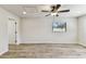 Bright bedroom featuring hardwood floors, a ceiling fan, and a window with natural light at 6551 S West Shore Cir, Tampa, FL 33616