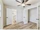 Bright bedroom with a ceiling fan, hardwood floors, and access to a bathroom and closet at 6551 S West Shore Cir, Tampa, FL 33616