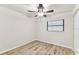 Bedroom with light wood flooring, window, and ceiling fan at 6551 S West Shore Cir, Tampa, FL 33616