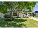 Charming single-story home with a covered carport and mature trees in a landscaped front yard at 6551 S West Shore Cir, Tampa, FL 33616