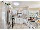 Updated kitchen with stainless steel appliances, white cabinets, and stylish countertops at 6551 S West Shore Cir, Tampa, FL 33616