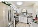 Well-lit kitchen featuring stainless steel appliances, white cabinetry, and a bright window at 6551 S West Shore Cir, Tampa, FL 33616