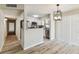 Bright kitchen and dining area with white cabinets, stainless appliances, and wood-look floors at 6551 S West Shore Cir, Tampa, FL 33616