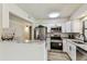 Charming kitchen with white cabinets, stainless steel appliances, and marble countertops at 6551 S West Shore Cir, Tampa, FL 33616