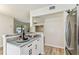 Open-concept kitchen featuring stone counter and stainless-steel refrigerator at 6551 S West Shore Cir, Tampa, FL 33616
