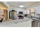 Bright kitchen boasts white cabinets, stainless steel appliances, and beautiful marble countertops at 6551 S West Shore Cir, Tampa, FL 33616