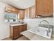 Functional laundry room with ample cabinet space, a convenient sink, and a window for natural light at 6551 S West Shore Cir, Tampa, FL 33616