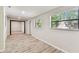 Bright, neutral living room with modern floors, natural light, and an open doorway at 6551 S West Shore Cir, Tampa, FL 33616