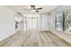 Inviting living room with wood-look floors, neutral paint, and access to the kitchen and entry at 6551 S West Shore Cir, Tampa, FL 33616