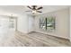 Living room featuring laminate flooring, ceiling fan, and natural light at 6551 S West Shore Cir, Tampa, FL 33616