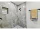 Modern shower with sleek gray tiling, built-in niche, and matte black fixtures at 6551 S West Shore Cir, Tampa, FL 33616