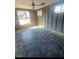 Partially remodeled bedroom with tile floors, exposed studs, and sunlit windows at 709 Pruitt Dr, Madeira Beach, FL 33708