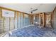 Bedroom needing full renovation with studs exposed and blue tile flooring at 709 Pruitt Dr, Madeira Beach, FL 33708