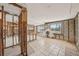 A blank slate living room needing full renovation with tile flooring, an open floorplan, and natural light at 709 Pruitt Dr, Madeira Beach, FL 33708