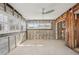 Living room area with multiple windows for natural lighting and ceiling fan at 709 Pruitt Dr, Madeira Beach, FL 33708