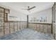 Spacious living room area featuring a ceiling fan and multiple windows at 709 Pruitt Dr, Madeira Beach, FL 33708
