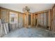 Living space needing full renovation with studs exposed and blue tile flooring at 709 Pruitt Dr, Madeira Beach, FL 33708