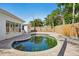 View of pool with privacy fence, pool-side patio, and exterior of the house at 709 Pruitt Dr, Madeira Beach, FL 33708