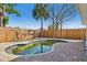 Pool view with a wooden fence providing privacy and a clear blue sky backdrop at 709 Pruitt Dr, Madeira Beach, FL 33708