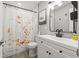 Well-lit bathroom featuring a vanity with modern fixtures, decorative shower curtain, and coordinated accents at 7307 34Th N Ave, St Petersburg, FL 33710