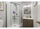 Modern bathroom showcasing a glass-enclosed shower, sleek vanity, and contemporary lighting fixtures at 7307 34Th N Ave, St Petersburg, FL 33710