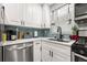 Close up of the updated kitchen features sleek stainless appliances and updated white cabinetry at 7307 34Th N Ave, St Petersburg, FL 33710