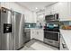 Updated kitchen features stainless steel appliances, white cabinets, and a stylish backsplash at 7307 34Th N Ave, St Petersburg, FL 33710