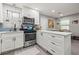 The open kitchen is equipped with stainless appliances, a gas range and updated cabinets at 7307 34Th N Ave, St Petersburg, FL 33710