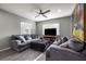 Cozy living room featuring plush seating, a ceiling fan, and natural light from two windows with modern decor at 7307 34Th N Ave, St Petersburg, FL 33710