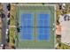 Aerial view of tennis courts surrounded by tropical landscaping and street parking at 7600 Sun Island S Dr # 407, South Pasadena, FL 33707