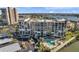 Aerial view of multi-story condo with a pool, parking and water views in a desirable neighborhood at 7600 Sun Island S Dr # 407, South Pasadena, FL 33707