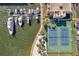 Aerial view of marina with tennis courts located in front of a modern building at 7600 Sun Island S Dr # 407, South Pasadena, FL 33707