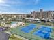An aerial view of the community including the pool, tennis courts and condominium building at 7600 Sun Island S Dr # 407, South Pasadena, FL 33707