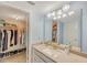 Bathroom vanity and open closet storage system with ample storage space for clothes and shoes at 7600 Sun Island S Dr # 407, South Pasadena, FL 33707