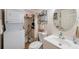 Bathroom showcasing a toilet, stacked washer/dryer, shower/tub with curtain and storage shelves above the toilet at 7600 Sun Island S Dr # 407, South Pasadena, FL 33707
