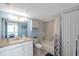 Bathroom with ample cabinet space, shower-tub combo, blue walls, and vanity area at 7600 Sun Island S Dr # 407, South Pasadena, FL 33707