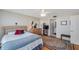 Cozy bedroom featuring a comfortable bed, dresser, TV, and ensuite bathroom at 7600 Sun Island S Dr # 407, South Pasadena, FL 33707