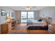 Bright bedroom with wood floors, ceiling fan, and a large window showcasing beautiful water views at 7600 Sun Island S Dr # 407, South Pasadena, FL 33707