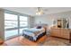 Bright bedroom features a large window with water views, hardwood floors, and a ceiling fan at 7600 Sun Island S Dr # 407, South Pasadena, FL 33707
