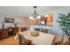 Inviting dining area featuring a chandelier, hardwood floors, and a view into the kitchen at 7600 Sun Island S Dr # 407, South Pasadena, FL 33707