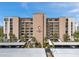 View of The Presidential 7600, a multi-story building with palm trees and covered parking at 7600 Sun Island S Dr # 407, South Pasadena, FL 33707