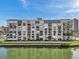 Exterior shot of a condo building showing multiple units with balconies overlooking the water at 7600 Sun Island S Dr # 407, South Pasadena, FL 33707
