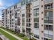 Charming multi-story condo building featuring private balconies with manicured landscaping and lush lawns at 7600 Sun Island S Dr # 407, South Pasadena, FL 33707