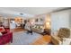 Open-concept living room and dining area with hardwood floors, modern furniture, and a view of the kitchen at 7600 Sun Island S Dr # 407, South Pasadena, FL 33707