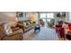 Bright living room showcases a comfortable sofa, chairs, a glass coffee table, and an area rug at 7600 Sun Island S Dr # 407, South Pasadena, FL 33707